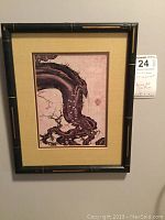 Framed Asian print featuring a stylized old plum tree with black and gold painted wooden frame and beige matting.