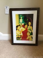 Framed numbered photo print leaning against wall displaying full frame and print in color.