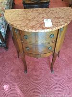 Front view showing demilune marble top and two drawers