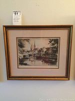 Framed black and white print showing St. Mary's Church with river and bridge, signed and dated by artist Paul Gxxx, 1919.
