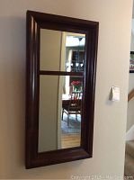 Full front view of the dark cherry wood framed rectangular wall mirror showing the upper and lower sections divided by the horizontal wooden slat.