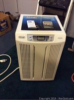 Front view of the DeLonghi dehumidifier showing white plastic body and air vents.
