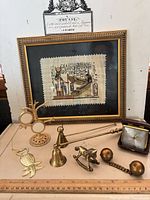 Group shot of all items including framed papyrus, clock and brass pieces