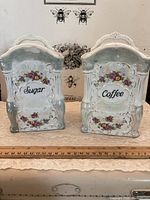 Front view of both Sugar and Coffee porcelain canisters