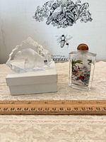 Crystal polar bear on box beside rectangular snuff bottle with ruler