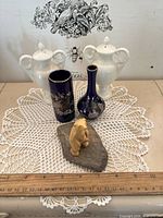 All six decorative items grouped on table with ruler for scale