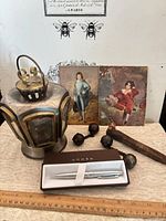 Group shot showing pen in box, lantern, prints, ball-and-chain sections, railway spike with ruler for scale