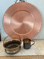 Group shot showing charger, brass bowl, metal cup