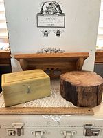 Front view of all items: wall shelf, yellow box, log box, doily