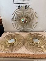 All three sunburst mirrors displayed to show quantity and overall condition