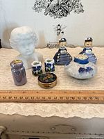 All eight miniature porcelain pieces displayed with ruler for scale