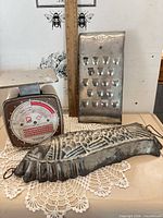 Overview of scale, fish mold and grater displayed together
