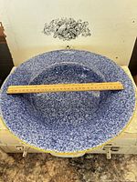 Top view showing blue speckle pattern and ruler across 16 in diameter