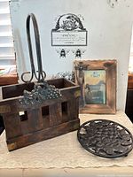Overall view of wooden caddy, photo frame and trivet