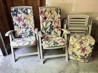 Two assembled chairs with cushions, two folded chairs stacked, bag with additional cushions visible