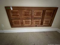 Full view of mounted carved wood door panel