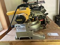 Rear and side view of DeWalt DW703 saw on bench showing overall condition and components