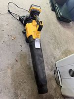 Full view of DEWALT blower with battery attached and charger beside