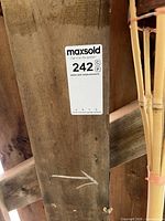 close-up view of lot label and bamboo tiki torch shafts