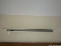 full view of glass shelf mounted on wall