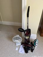 Overall lot view showing vacuum, fan, iron, attachments, manual