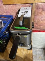 Top view of Kalorik FT 43721 deep fryer with manual resting on lid