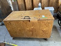 Full view of plywood storage chest showing handle, latch and overall condition
