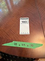 Tabletop showing wood grain and measurement tape