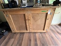 Front view of closed wooden rolling workbench