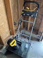 Full view of Yardworks snow thrower showing handle, body, wheels
