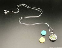 Full necklace showing chain, pendant and two lava stone pads