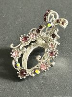 Front view of silver-tone dress clip with rhinestones