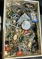 Overview of full box showing mixed jewelry pieces