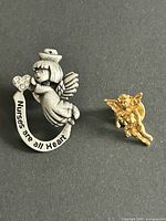 Front view of both pins showing designs and colors