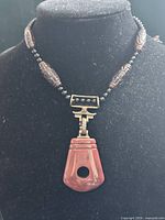 Full view of necklace on bust showing beads and pendant