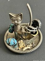 Front view of cat ring holder with rings and charms