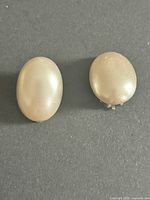 Front view of both oval faux-pearl earrings