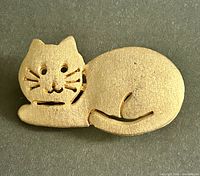 Front view of gold-tone cat brooch