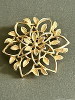 Front view of gold-tone floral brooch