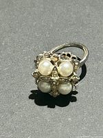Top view showing faux pearls, rhinestones, filigree design