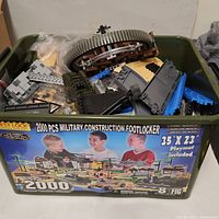 Overview of green footlocker showing original label and mixed bricks inside