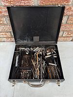 Open metal case showing full assortment of sockets, hex keys, bits and accessories