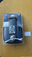 Front view of sealed package displaying black plastic housed mirror