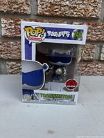 Front of boxed Toonami Tom #749 figure showing EB Exclusive sticker