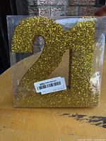 Gold glitter foam "21" topper in clear plastic box