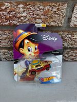 Front view of sealed Hot Wheels Pinocchio Character Car on bent card