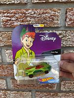 Front view of sealed Hot Wheels Peter Pan Character Car on blister card