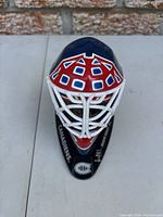 Front view of mini goalie mask on stand