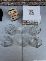 Top view showing six assorted rocks glasses, Rossini box and Seagram's VO packaging