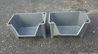 Two gray open-front stackable plastic storage bins shown side by side on pavement